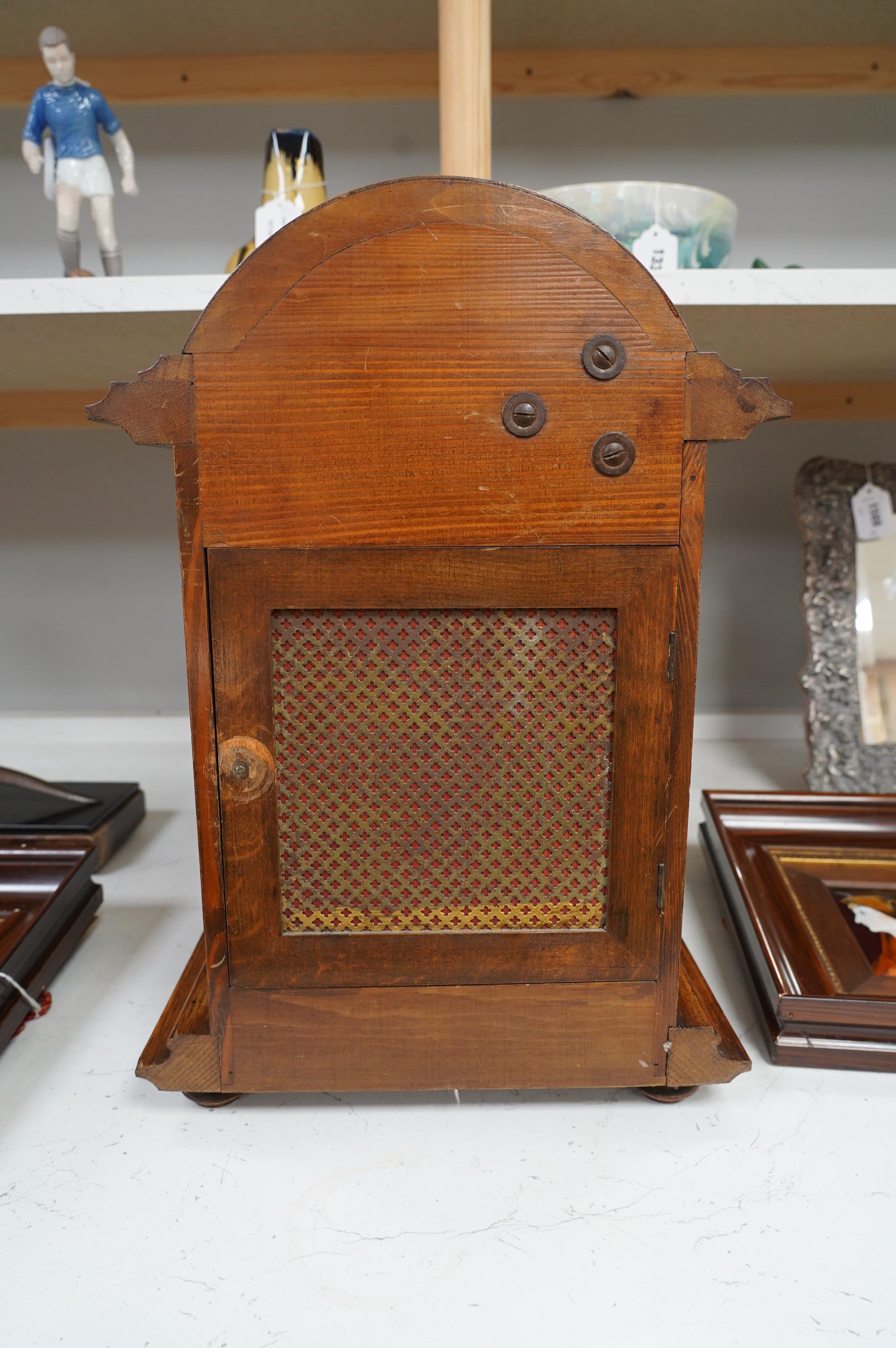 An oak bracket clock with a German three train movement, chiming on five gongs, 47cm high. Condition - fair to good, some wear to chapter ring, etc.